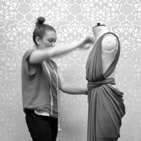 A photo of Abigail Eaton draping a dress on the stand